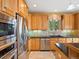 Kitchen features stainless steel appliances, granite countertops, and tile backsplash at 16631 Red Cliff Cir, Morrison, CO 80465