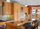 Kitchen with breakfast bar, under cabinet lighting, tile backsplash, and ample storage at 16631 Red Cliff Cir, Morrison, CO 80465