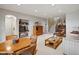 Open-concept living room with built-in shelving, a piano, and a cozy seating area at 16631 Red Cliff Cir, Morrison, CO 80465