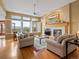 Bright living room with large windows, hardwood floors, and a cozy fireplace at 16631 Red Cliff Cir, Morrison, CO 80465