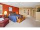 Spacious main bedroom featuring a cozy sitting area, warm lighting, and view into luxurious ensuite bathroom at 16631 Red Cliff Cir, Morrison, CO 80465
