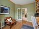 Cozy office space featuring built-in bookshelves, hardwood floors, and ample natural light at 16631 Red Cliff Cir, Morrison, CO 80465