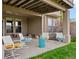 A cozy, covered patio is shown featuring comfortable seating, making it perfect for relaxation and outdoor enjoyment at 16631 Red Cliff Cir, Morrison, CO 80465