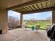 Covered patio with outdoor seating offers beautiful views of the golf course and surrounding landscape for relaxation and entertainment at 16631 Red Cliff Cir, Morrison, CO 80465
