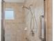 Modern shower with adjustable shower head, grab bar, and tiled walls, offering a comfortable and safe bathing experience at 16631 Red Cliff Cir, Morrison, CO 80465