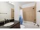 Bathroom featuring a tiled shower/tub combo and granite topped vanity at 11227 Explorers Run, Littleton, CO 80125
