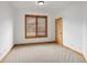 The bedroom offers neutral carpet, wood trim, and a bright window, perfect for relaxation at 11227 Explorers Run, Littleton, CO 80125