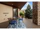 Cozy covered deck featuring outdoor seating with a mountain view for comfortable relaxation and entertaining at 11227 Explorers Run, Littleton, CO 80125