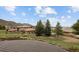 Luxury houses with terracotta roofs and stucco walls, nestled in a green landscape with mountain views at 11227 Explorers Run, Littleton, CO 80125