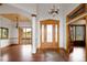 Elegant foyer with hardwood floors, decorative columns, and a custom front door at 11227 Explorers Run, Littleton, CO 80125