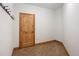 Hallway with wood door and coat hooks at 11227 Explorers Run, Littleton, CO 80125