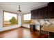 Bright kitchen with built-in desk, hardwood floors, and views at 11227 Explorers Run, Littleton, CO 80125
