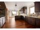 Modern kitchen with dark wood cabinets, stainless steel appliances, and a breakfast nook at 11227 Explorers Run, Littleton, CO 80125