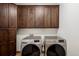 Convenient laundry room with front load washer and dryer set and lots of cabinet storage at 11227 Explorers Run, Littleton, CO 80125