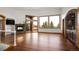 Bright living room with fireplace, hardwood floors, large windows with natural light, and mountain views at 11227 Explorers Run, Littleton, CO 80125