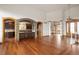 Open living room featuring hardwood floors, stone archway, and seamless transition into the kitchen at 11227 Explorers Run, Littleton, CO 80125