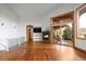 Bright living room featuring hardwood floors, a fireplace, and access to a deck for seamless indoor-outdoor living at 11227 Explorers Run, Littleton, CO 80125
