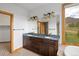 Beautiful main bathroom has dual sinks, granite countertop, ample cabinet space, and large mirror at 11227 Explorers Run, Littleton, CO 80125