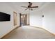 Large main bedroom features neutral carpet, recessed ceilings, wood trim, and access to a private balcony at 11227 Explorers Run, Littleton, CO 80125