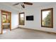 Spacious main bedroom features neutral carpet, wood trim, a ceiling fan, and great natural light at 11227 Explorers Run, Littleton, CO 80125