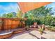 Charming backyard space with a fountain, stone bench, and lush greenery at 21863 E Oxford Pl, Aurora, CO 80018