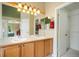 Double vanity bathroom with ample lighting and storage with door to closet at 21863 E Oxford Pl, Aurora, CO 80018