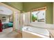 Bathroom with shower, tub, and view into the bedroom at 21863 E Oxford Pl, Aurora, CO 80018
