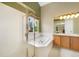 Bright bathroom features a soaking tub and glass-enclosed shower at 21863 E Oxford Pl, Aurora, CO 80018