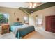 Bedroom with ensuite bathroom featuring an archway, ceiling fan, and southwest decor at 21863 E Oxford Pl, Aurora, CO 80018