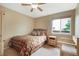 Comfortable bedroom featuring a bed with patterned bedding and a window at 21863 E Oxford Pl, Aurora, CO 80018