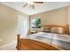 Bedroom featuring a wooden bed with a plaid comforter, a side table, and a window at 21863 E Oxford Pl, Aurora, CO 80018