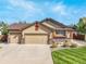 Charming single-Gathering home featuring a three-car garage, lush lawn, and inviting curb appeal at 21863 E Oxford Pl, Aurora, CO 80018