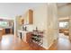 Kitchen featuring wood cabinets, a wine rack, hardwood floors, and ample counter space at 21863 E Oxford Pl, Aurora, CO 80018