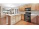 Well-lit kitchen showcasing a gas stove and modern appliances with light wood cabinets and tile countertops at 21863 E Oxford Pl, Aurora, CO 80018
