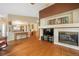Spacious living room with an open layout, hardwood floors, fireplace, and seamless flow to the kitchen at 21863 E Oxford Pl, Aurora, CO 80018