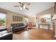 Open-concept living room featuring a neutral color palette, hardwood floors, and great natural light at 21863 E Oxford Pl, Aurora, CO 80018