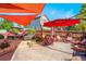 Outdoor patio area complete with shade sails, a fire pit and comfortable seating at 21863 E Oxford Pl, Aurora, CO 80018