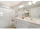 Main bathroom with double vanity, large mirror, and shower at 9876 Ceylon Ct, Commerce City, CO 80022