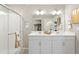 Elegant bathroom with double vanity, large mirror, and shower at 9876 Ceylon Ct, Commerce City, CO 80022