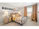 Charming bedroom with a metal bed frame and playful decor at 9876 Ceylon Ct, Commerce City, CO 80022