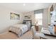 Cozy bedroom with a single bed, desk, and window seat at 9876 Ceylon Ct, Commerce City, CO 80022