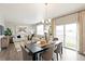 Dining area with hardwood floors, sliding doors to backyard and adjacent kitchen at 9876 Ceylon Ct, Commerce City, CO 80022
