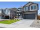 Two-story house with gray siding, stone accents, and a two-car garage at 9876 Ceylon Ct, Commerce City, CO 80022