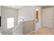 Upstairs hallway with carpet, access to bedrooms, and a window at 9876 Ceylon Ct, Commerce City, CO 80022