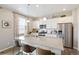 Modern kitchen with white cabinets, stainless steel appliances, and an island at 9876 Ceylon Ct, Commerce City, CO 80022