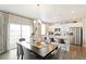 Modern kitchen with white cabinets, stainless steel appliances, and an island at 9876 Ceylon Ct, Commerce City, CO 80022