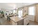 Open concept kitchen with island, stainless steel appliances, and view of living room at 9876 Ceylon Ct, Commerce City, CO 80022