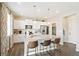 Modern kitchen with island, stainless steel appliances, and hardwood floors at 9876 Ceylon Ct, Commerce City, CO 80022