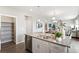 Kitchen island with double sink, dishwasher, and pantry at 9876 Ceylon Ct, Commerce City, CO 80022
