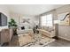 Comfortable living room with hardwood floors, neutral decor, and a large window at 9876 Ceylon Ct, Commerce City, CO 80022